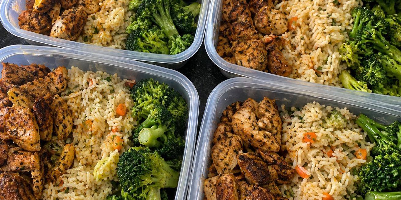 Meal prep containers of spiced chicken, herbed rice and broccoli